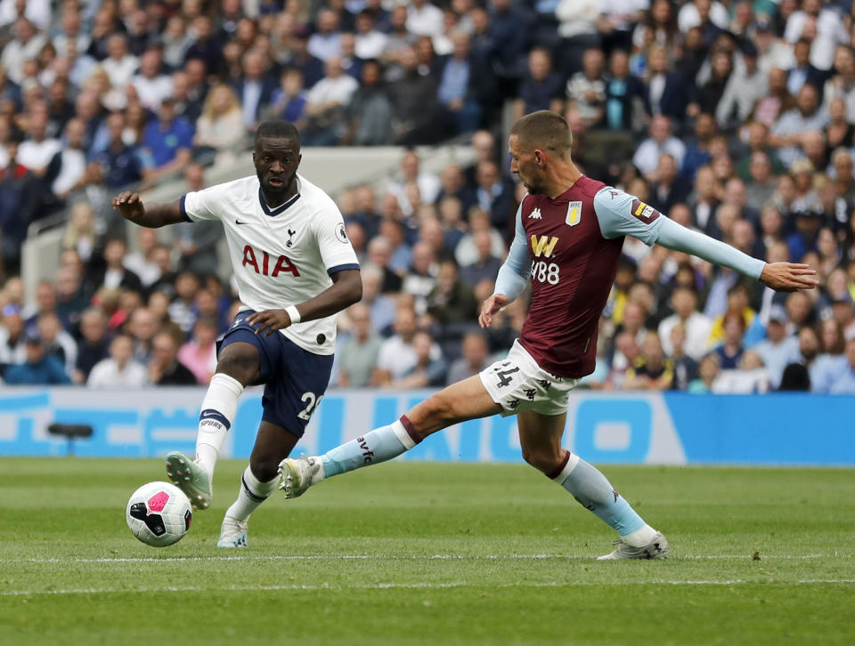 Tottenham's Tanguy Ndombele, left, duels for the ball with Aston Villa's Conor Hourihane during the English Premier League soccer match between Tottenham Hotspur and Aston Villa at the Tottenham Hotspur stadium in London, Saturday, Aug. 10, 2019. (AP Photo/Frank Augstein)