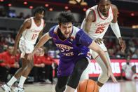 Northwestern State forward Zurabi Zhgenti (35) and Houston center Josh Carlton (25) watch the ball during the first half of an NCAA college basketball game Tuesday, Nov. 30, 2021, in Houston. (AP Photo/Justin Rex)