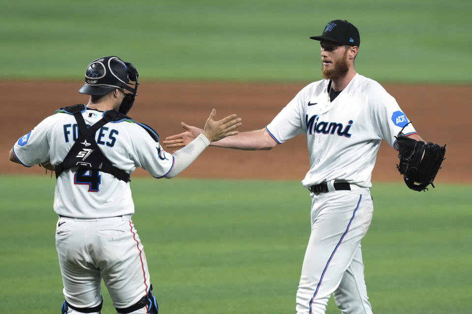 Miami Marlins relief pitcher A.J. Puk and catcher Nick Fortes (4) congratulate each other after defeating the Chicago Cubs, Sunday, April 30, 2023, in Miami. (AP Photo/Marta Lavandier)