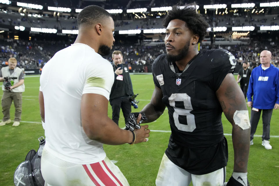 New York Giants running back Saquon Barkley greets Las Vegas Raiders running back Josh Jacobs (8) after an NFL football game, Sunday, Nov. 5, 2023, in Las Vegas. (AP Photo/Rick Scuteri)