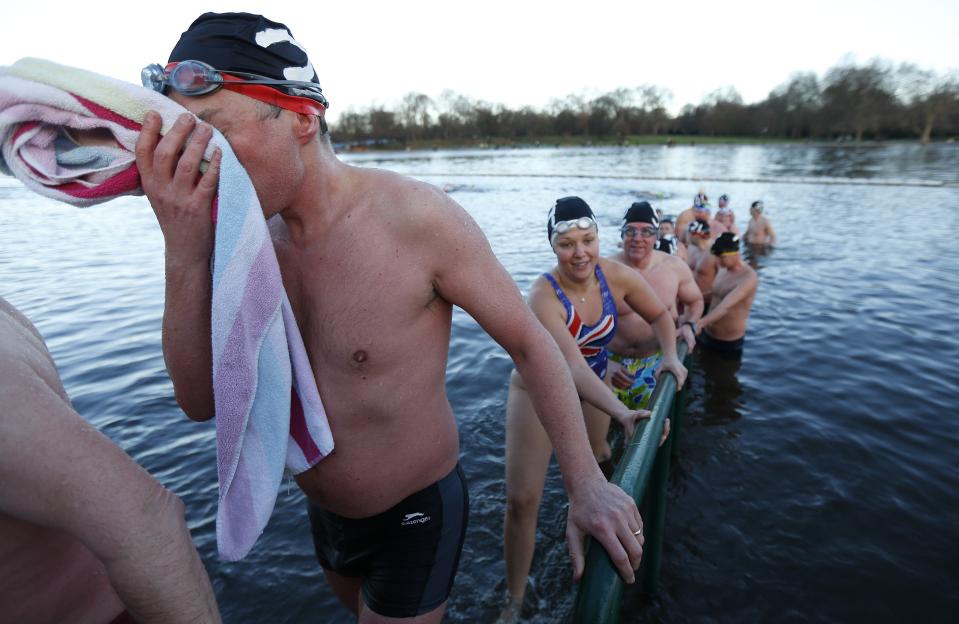 Swimmers emerge from the Serpentine river on Christmas Day in Hyde Park, central London