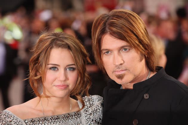 Miley Cyrus and her father, Billy Ray Cyrus, arrive at the film premiere of 