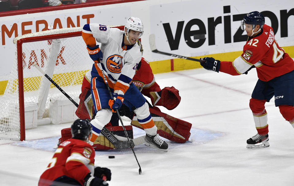 New York Islanders left wing Pierre Engvall (18) tries to score while standing in front of Florida Panthers goaltender Anthony Stolarz during the second period of an NHL hockey game, Saturday, Dec. 2, 2023, in Sunrise, Fla. (AP Photo/Michael Laughlin)