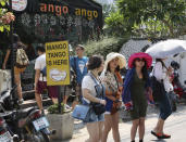 In this March 30, 2014, Chinese tourists walk in and out to eat at a restaurant, one of the most favorite spots for Chinee tourist, in Chiang Mai province, northern Thailand. The bucolic, once laid-back, campus of one of Thailand’s top universities seems to be under a security clampdown these days. Not against a terrorist threat, but Chinese tourists, thousands of them, who have clambered aboard student buses, eaten in cafeterias, sneaked into classes to attend lectures and even pitched a tent by a picturesque lake. Now visitors are restricted to entering through a single gate manned by Mandarin-speaking volunteers who direct Chinese tourists to a line of vehicles for guided tours. (AP Photo/Apichart Weerawong)