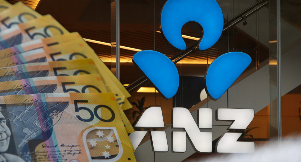 Wad of $50 notes next to ANZ sign