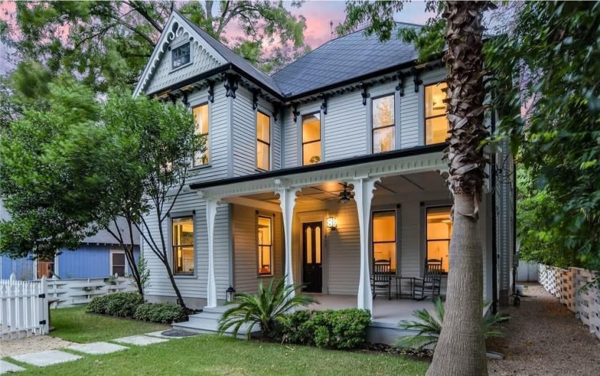 Built in 1890, the three-story home boasts original details such as hand-carved trim, longleaf pine floors and an antique doorbell.