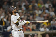 San Diego Padres' Fernando Tatis Jr. watches his home run ball during the seventh inning of a baseball game against the San Francisco Giants, Wednesday, Sept. 22, 2021, in San Diego. (AP Photo/Gregory Bull)