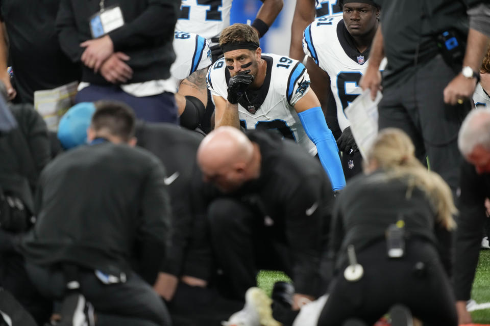 Players from both teams watch on as medical staff tend to Chandler Zavala on the field. (AP Photo/Carlos Osorio)