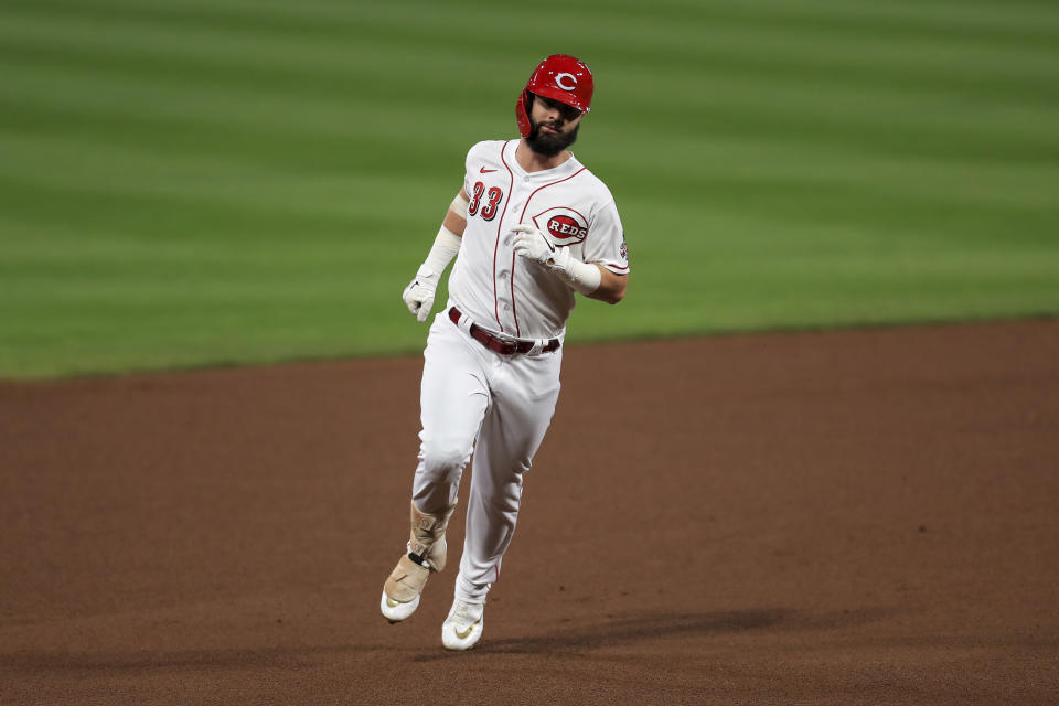 Cincinnati Reds' Jesse Winker runs the bases after hitting a solo home run during the fourth inning of the team's baseball game against the Milwaukee Brewers in Cincinnati, Wednesday, Sept. 23, 2020. (AP Photo/Aaron Doster)