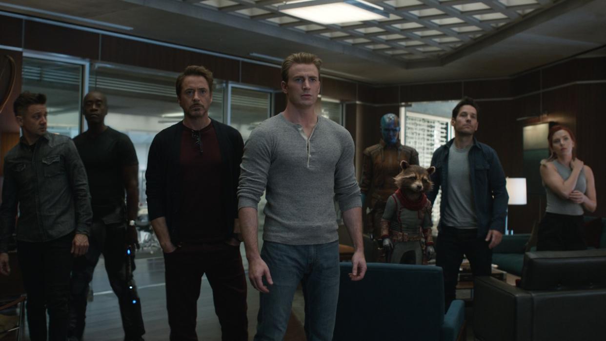  From left to right: Hawkeye, War Machine, Iron Man, Captain America, Nebula, Rocket, Ant-Man and Black Widow standing together out of uniform in Avengers: Endgame. 