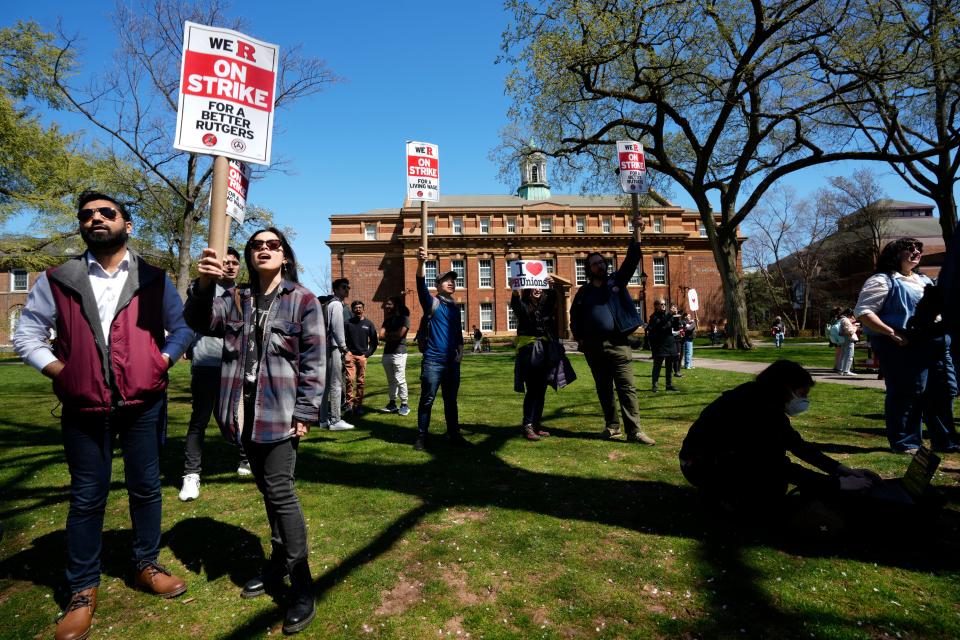 Graduate student, Gabrielle Lopez (holding sign, wearing sunglasses, foreground), of Edison, was among hundreds who rallied for a new contract on the New Brunswick campus of Rutgers University. Monday, April 10, 2023 