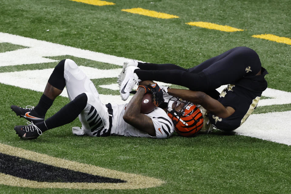 Cincinnati Bengals wide receiver Ja'Marr Chase, left, catches a touchdown pass New Orleans Saints cornerback Paulson Adebo, right, defends during the second half of an NFL football game in New Orleans, Sunday, Oct. 16, 2022. (AP Photo/Butch Dill)