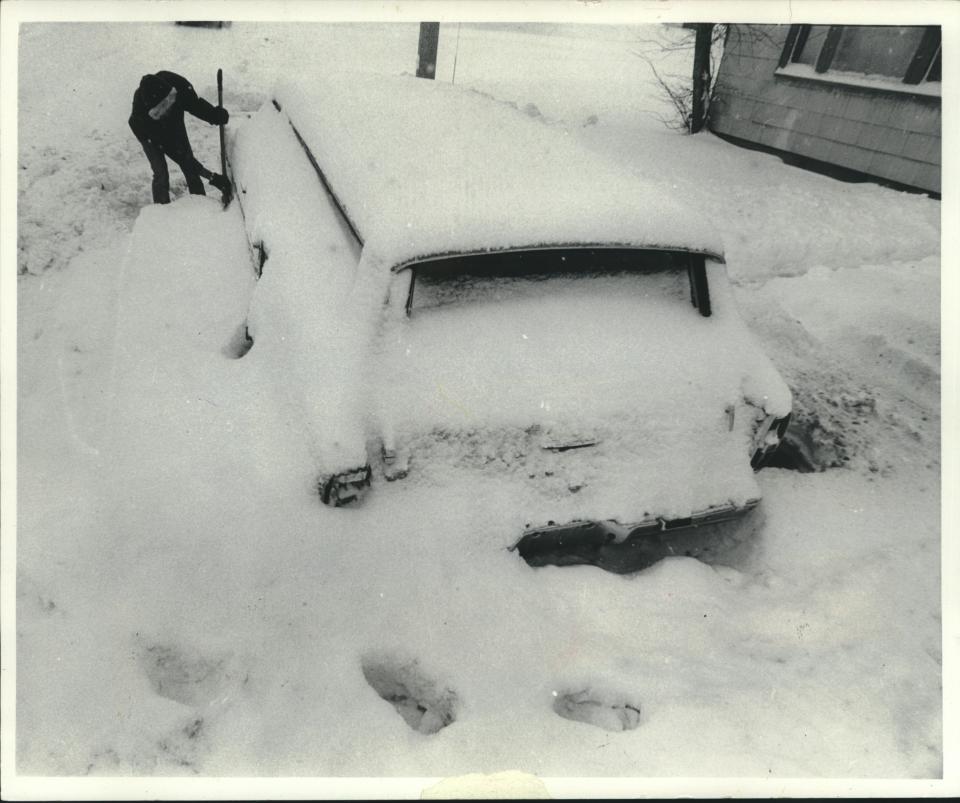 Joseph Jones tries to dig out his car on West Hampton Avenue on Jan. 1, 1979, after a New Year's Eve blizzard dumped more than 13 inches of snow on Milwaukee. This photo was published in the Jan. 2, 1979, Milwaukee Sentinel.