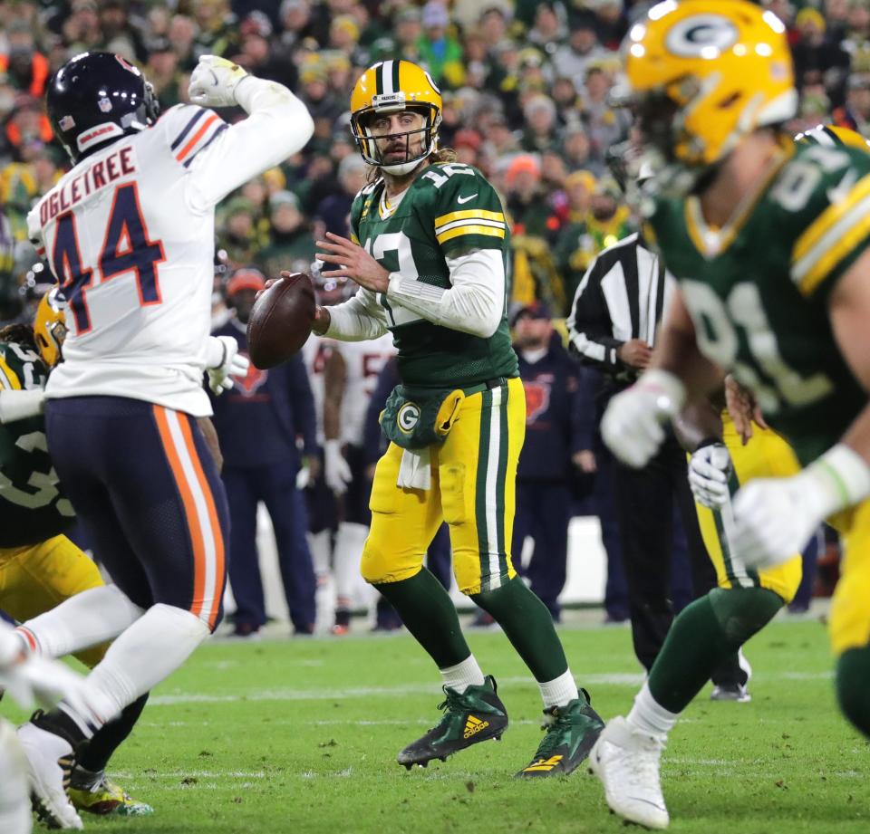 Green Bay Packers quarterback Aaron Rodgers (12) looks for an open receiver during their game Sunday, December 12, 2021 at Lambeau Field in Green Bay, Wis. The Green Bay Packers beat the Chicago Bears 45-30.