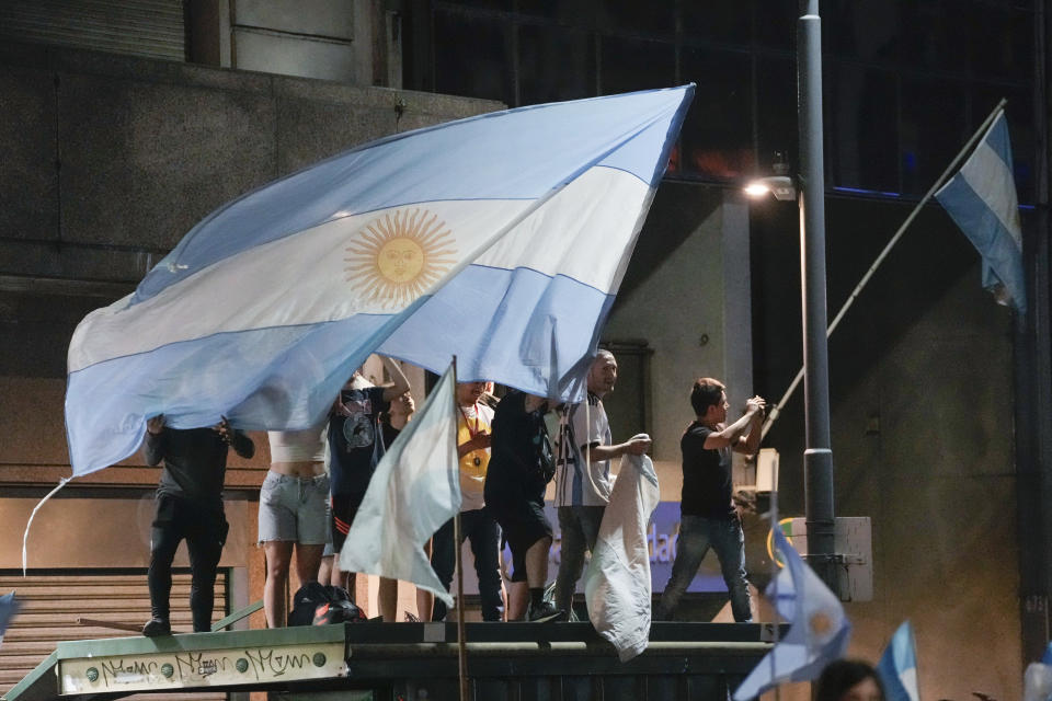 Supporters of Javier Milei celebrate his victory over Sergio Massa, the Economy Minister and candidate of the Peronist party, in the presidential runoff election in Buenos Aires, Argentina, Sunday, Nov. 19, 2023. (AP Photo/Rodrigo Abd)