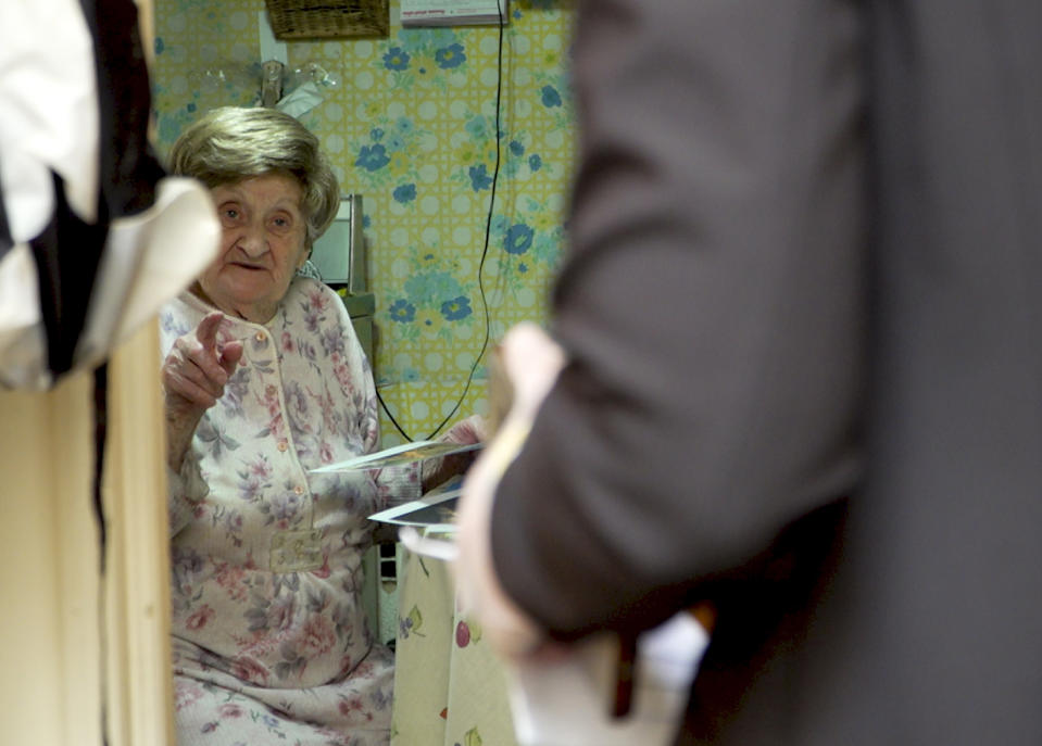 In this March 19, 2020 photo, Holocaust survivor Hannah Nudel talks to volunteer Freida Rothman, who is delivering meals to survivors isolated in their homes because of coronavirus concerns, in Brooklyn, New York. (AP Photo/Jessie Wardarski)