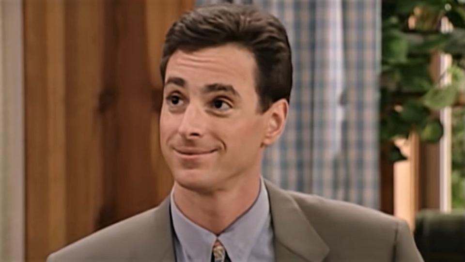 Bob Saget as Danny Tanner, smiling on Full House.