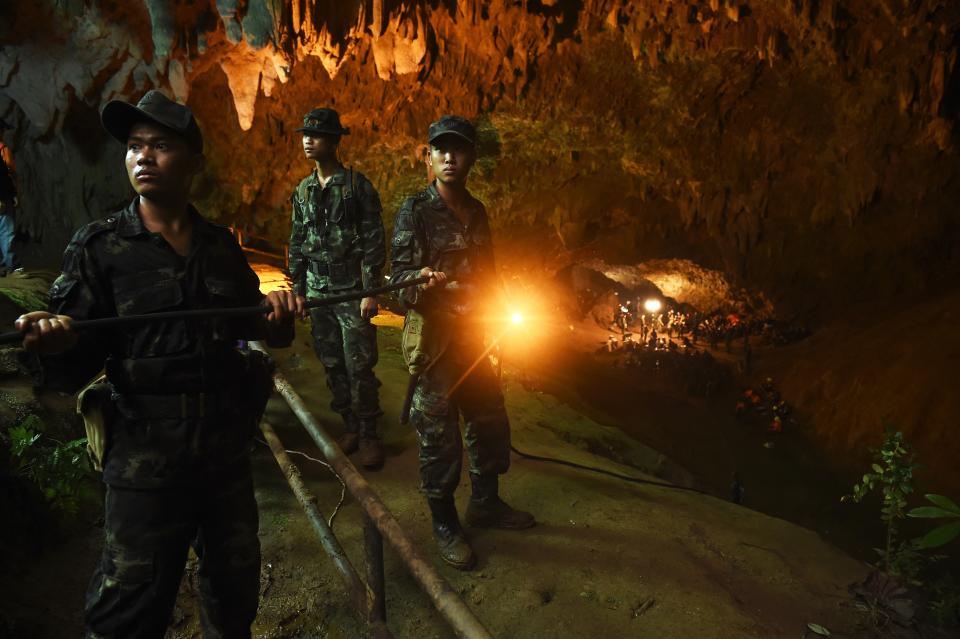 Thai soldiers relay electric cable deep into the Tham Luang cave at the Khun Nam Nang Non Forest Park in Chiang Rai on June 26, 2018.