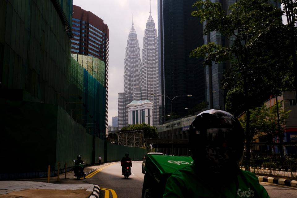 A near-empty street near the Petronas Twin Towers during a Movement Control Order (MCO) in Kuala Lumpur, Malaysia, on Wednesday, Aug. 11, 2021. Photographer: Samsul Said/Bloomberg