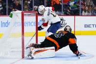 Florida Panthers' Jonathan Huberdeau, left, scores a goal past Philadelphia Flyers' Carter Hart during the third period of an NHL hockey game, Saturday, Oct. 23, 2021, in Philadelphia. (AP Photo/Matt Slocum)