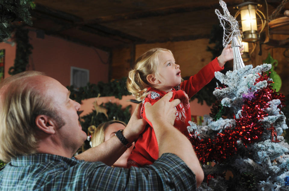Bob helping charlie put the angel on top of the tree in Good Luck Charlie, It's Christmas!