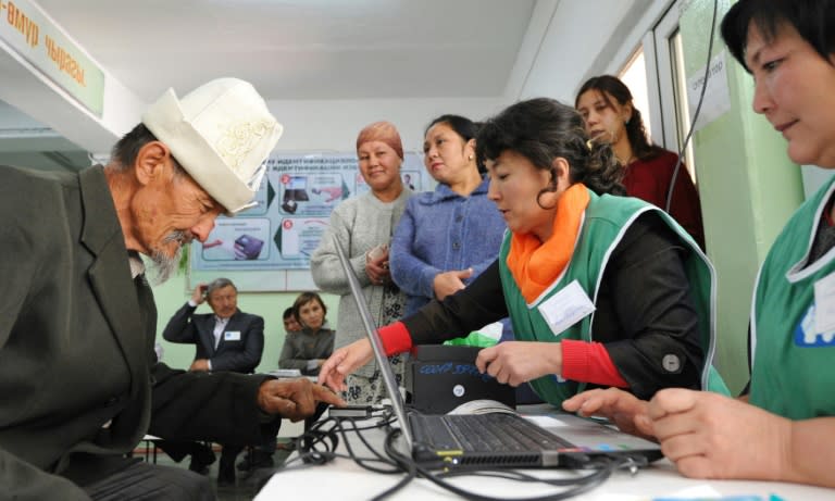 A man gives his fingerprints at a polling station during Kyrgyz parliamentary elections in the village of Kara-Zhigach, outside Bishkek, on October 4, 2015