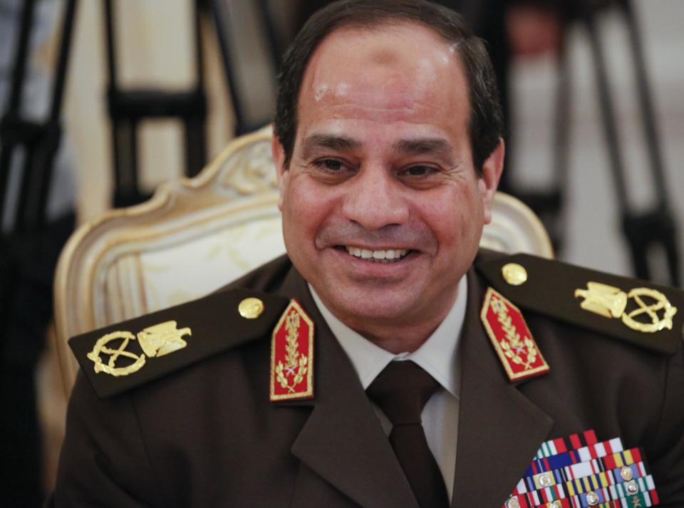 FILE - In this Thursday, Feb. 13, 2014 file photo, Egypt’s military chief Field Marshal Abdel-Fattah el-Sissi smiles as he speaks to Foreign Minister Sergey Lavrov during their talks along with Egyptian Foreign Minister Nabil Fahmy and Russian Defense Minister Sergei Shoigu in Moscow, Russia. On Saturday, March, 8, 2014 interim Egyptian President Adly Mansour issued a law regulating the upcoming Presidential election, which is expected to be held by the end of April. As he nears announcing a run for Egypt’s presidency, El-Sissi has been focusing on preparing an economic program, senior generals and government officials say, demonstrating the wariness within the military over the scale of problems facing the country. (AP Photo/Alexander Zemlianichenko, File)