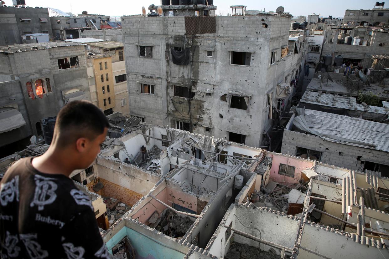 Palestinians inspect houses damaged in an Israeli strike in Rafah, southern Gaza (REUTERS)