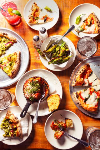 <p>Cedric Angeles</p> Wood-fired pizzas are baked in a 900-degree oven at Bella Luna.