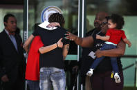 <p>Mourners embrace as they leave a wake for Stephon Clark at the Boss Church on March 28, 2018 in Sacramento, Calif. (Photo: Justin Sullivan/Getty Images) </p>