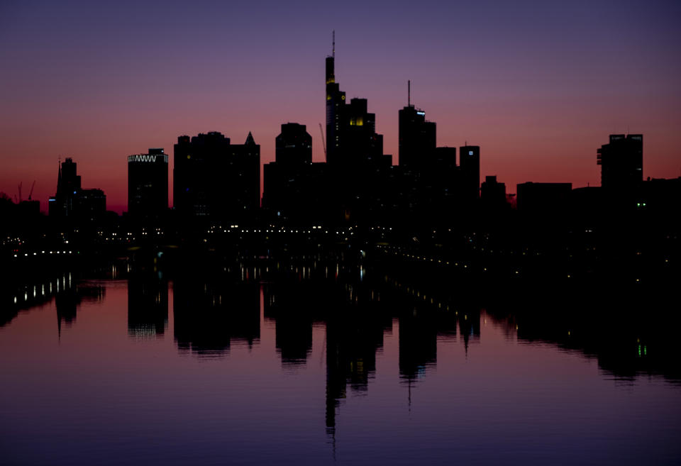 FILE - In this April 1, 2020 file photo, the buildings of the banking district are reflected in the river Main in Frankfurt, Germany. Due to the coronavirus the economy worldwide expects heavy losses. More than 50,000 people have died after contracting COVID-19 in Germany, a number that has risen swiftly over recent weeks as the country has struggled to bring down infection figures. (AP Photo/Michael Probst, File)