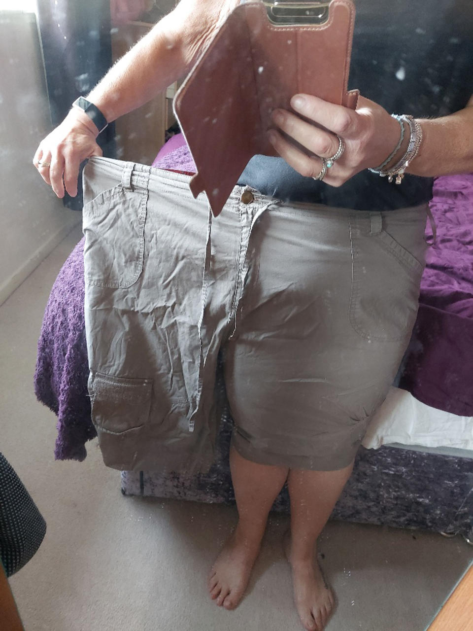 Tracey Hewitt showing how big her trousers are for her now after weight loss. (Caters)