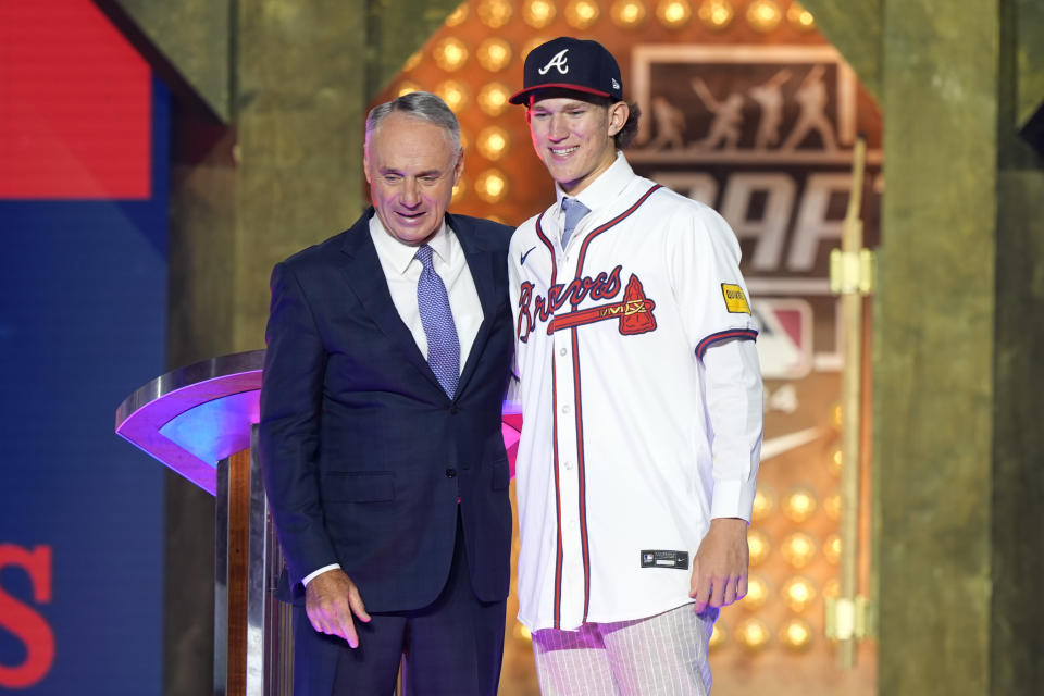 Major League Baseball Commissioner Rob Manfred, left, poses for a photo with Cam Caminiti after Caminiti was selected 24th overall by the Atlanta Braves in the first round of the MLB baseball draft in Fort Worth, Texas, Sunday, July 14, 2024. (AP Photo/LM Otero)