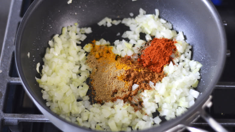 onions and spices in pan