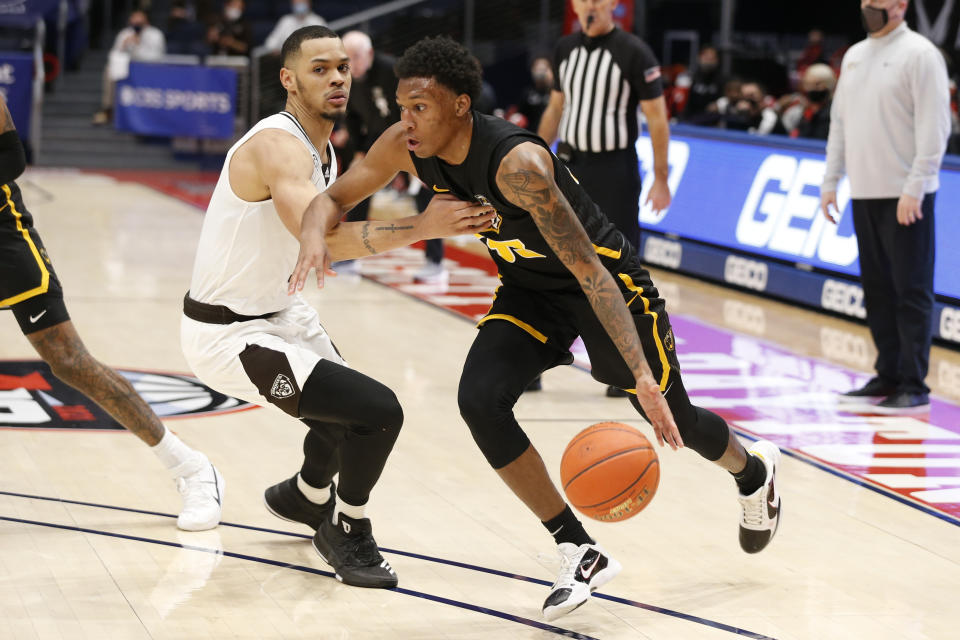 VCU's Josh Banks, right, drives the baseline past St. Bonaventure's Dominick Welch during the second half of an NCAA college basketball championship game for the Atlantic Ten Conference tournament Sunday, March 14, 2021, in Dayton, Ohio. (AP Photo/Jay LaPrete)