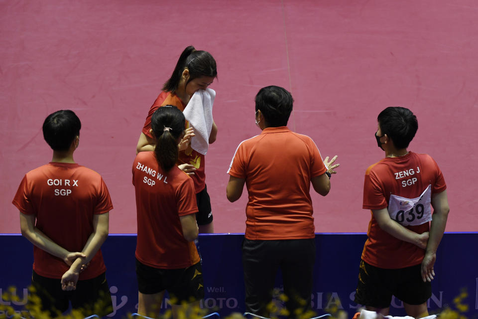 Singapore women's table tennis head coach Jing Junhong (second from right) speaking to Wong Xin Ru during the women's team final at the Hanoi SEA Games. (PHOTO: Sport Singapore/ Alfie Lee)