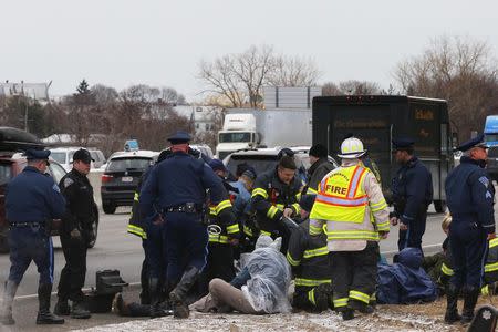 Police detain a group of protesters who blocked Interstate 93 southbound during the morning rush hour in Somerville, Massachusetts January 15, 2015. REUTERS/Brian Snyder