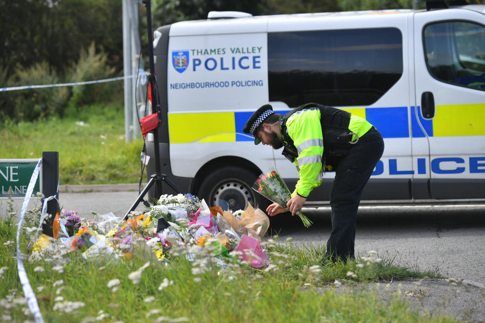 A police officer lays a floral tribute at the scene, where Thames Valley Police officer Pc Andrew Harper, 28, died following a "serious incident" at about 11.30pm on Thursday near the A4 Bath Road, between Reading and Newbury, at the village of Sulhamstead in Berkshire.