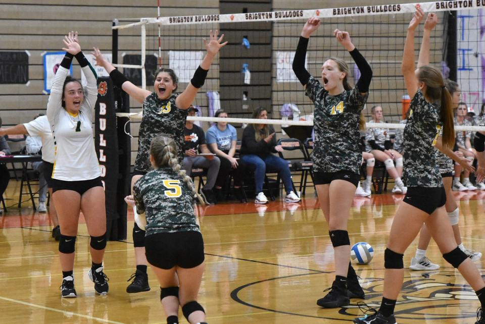 Howell volleyball players celebrate a point during a 3-0 sweep of Brighton on Tuesday, Oct. 4, 2022.