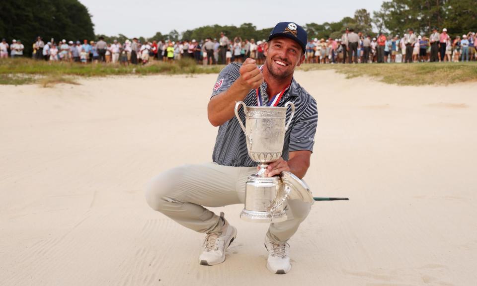 <span>Bryson DeChambeau pours sand from a bunker into the US Open trophy, after his superb up-and-down approach shot secured the title.</span><span>Photograph: Gregory Shamus/Getty Images</span>