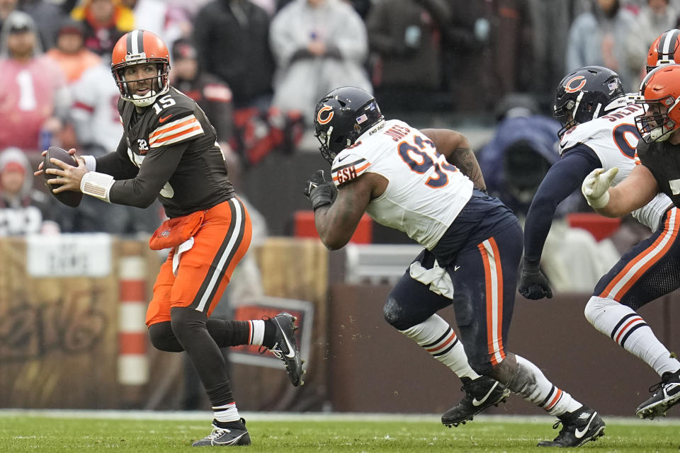 Cleveland Browns quarterback Joe Flacco (15) passes the ball with pressure from Chicago Bears defensive tackle Justin Jones (93) in the first half of an NFL football game in Cleveland, Sunday, Dec. 17, 2023. (AP Photo/Sue Ogrocki)