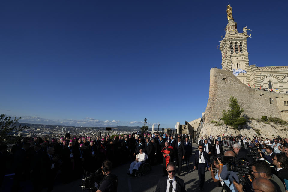 Pope Francis passes in front of the Notre Dame de la Garde Basilica as he reaches the Memorial dedicated to sailors and migrants lost at sea for a moment of reflection with religious leaders, in Marseille, France, Friday, Sept. 22, 2023. Francis, during a two-day visit, will join Catholic bishops from the Mediterranean region on discussions that will largely focus on migration. (AP Photo/Pavel Golovkin)