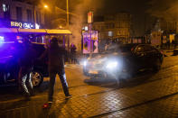 The escorted official car of Belgium's King Philippe makes a turn to avoid protestors in the Belgium capital, Brussels, Wednesday, Jan. 13, 2021, at the end of a protest asking for authorities to shed light on the circumstances surrounding the death of a 23-year-old Black man who was detained by police last week in Brussels. The demonstration in downtown Brussels was largely peaceful but was marred by incidents sparked by rioters who threw projectiles at police forces and set fires before it was dispersed. (AP Photo/Francisco Seco)