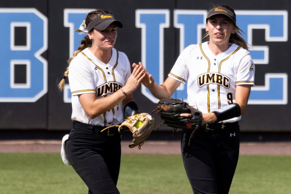 UMBC catcher Karly Keating #3 high-fives UMBC outfielder Sierra Pierce #9 during an NCAA softball game on Friday, May 20, 2022, in Durham, N.C. (AP Photo/Kara Durrette)