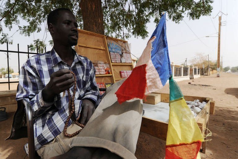 A stallholder sells French and Malian flags on the side of the road in Gao, northern Mali on February 1, 2013. President Francois Hollande prepared to visit Mali as French-led troops worked Friday to secure the last Islamist stronghold in the north after a lightning offensive against the extremists