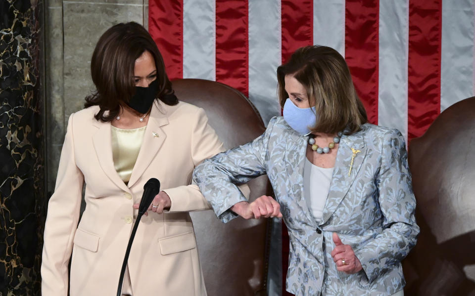 FILE - Vice President Kamala Harris, left, greets House Speaker Nancy Pelosi of Calif., ahead of President Joe Biden addressing a joint session of Congress, April 28, 2021, in the House Chamber at the U.S. Capitol in Washington. (Jim Watson/Pool via AP, File)