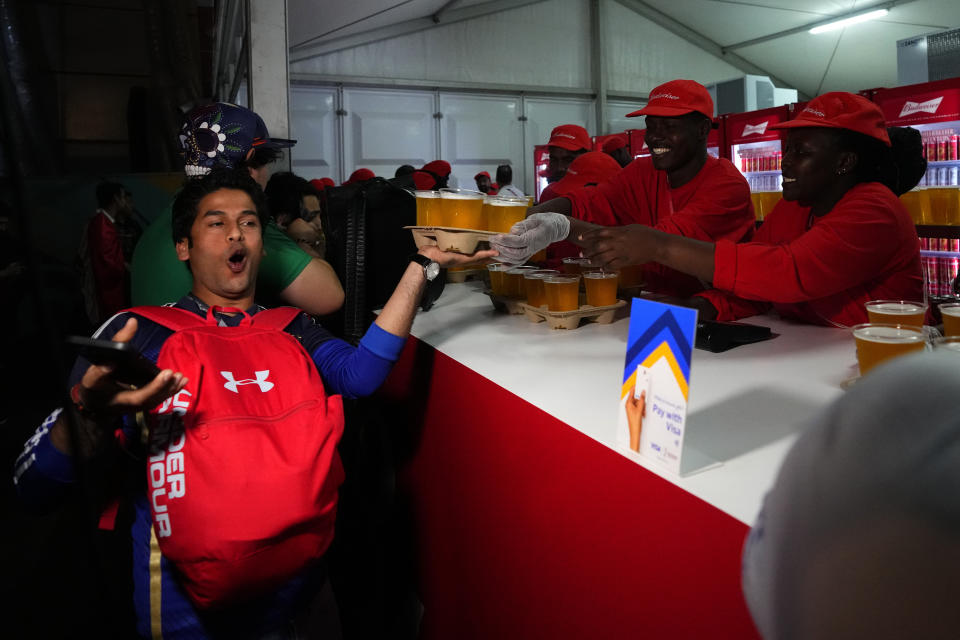Fan buys his beers at a fan zone ahead of the FIFA World Cup, in Doha, Qatar Saturday, Nov. 19, 2022. (AP Photo/Petr Josek)