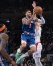 New York Knicks forward Obi Toppin (1) dunks against Los Angeles Clippers guard Luke Kennard, right, during the first half of an NBA basketball game, Sunday, Jan. 23, 2022, in New York. (AP Photo/John Minchillo)