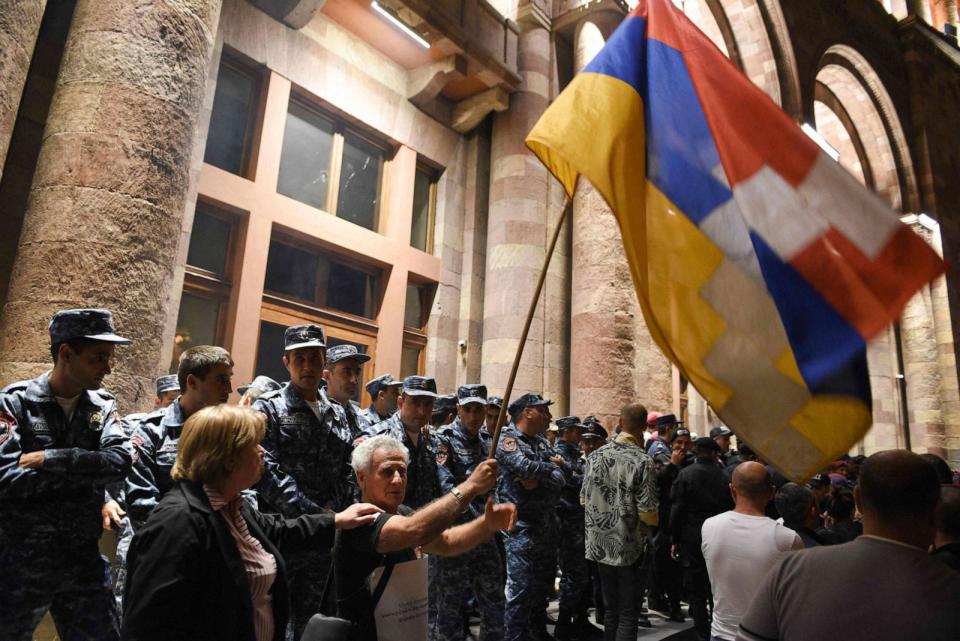 PHOTO: Armenian police officers guard the entrance to the government building during clashes with protesters calling on Armenian Prime Minister Nikol Pashinyan to resign in central Yerevan on Sept. 19, 2023. (Karen Minasyan/AFP via Getty Images)