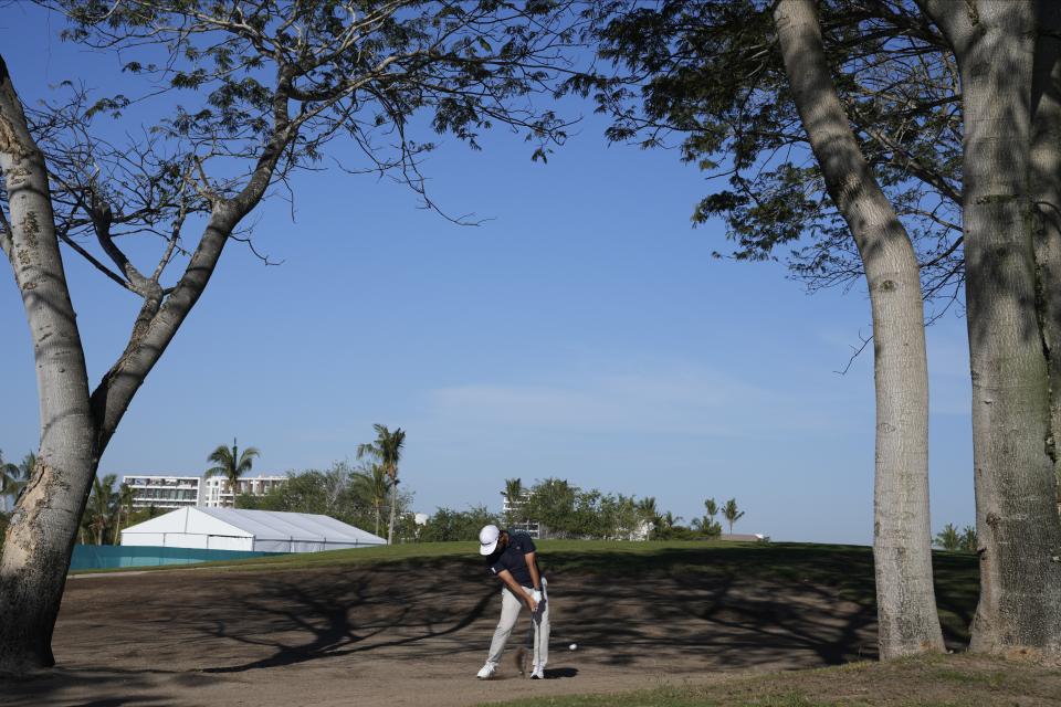 Ryo Hisatsune, of Japan, hits from the rough at the first hole during the first round of the Mexico Open golf tournament in Puerto Vallarta, Mexico, Thursday, Feb. 22, 2024. (AP Photo/Fernando Llano)